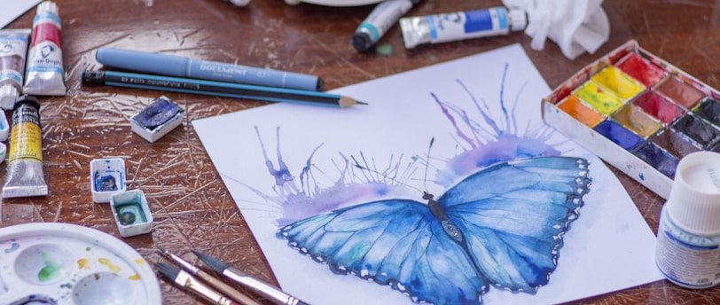 blue and purple click pen on white paper